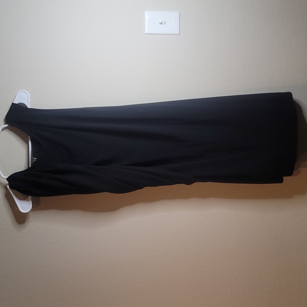 Is black dress with shawl and faux leather detail on the back